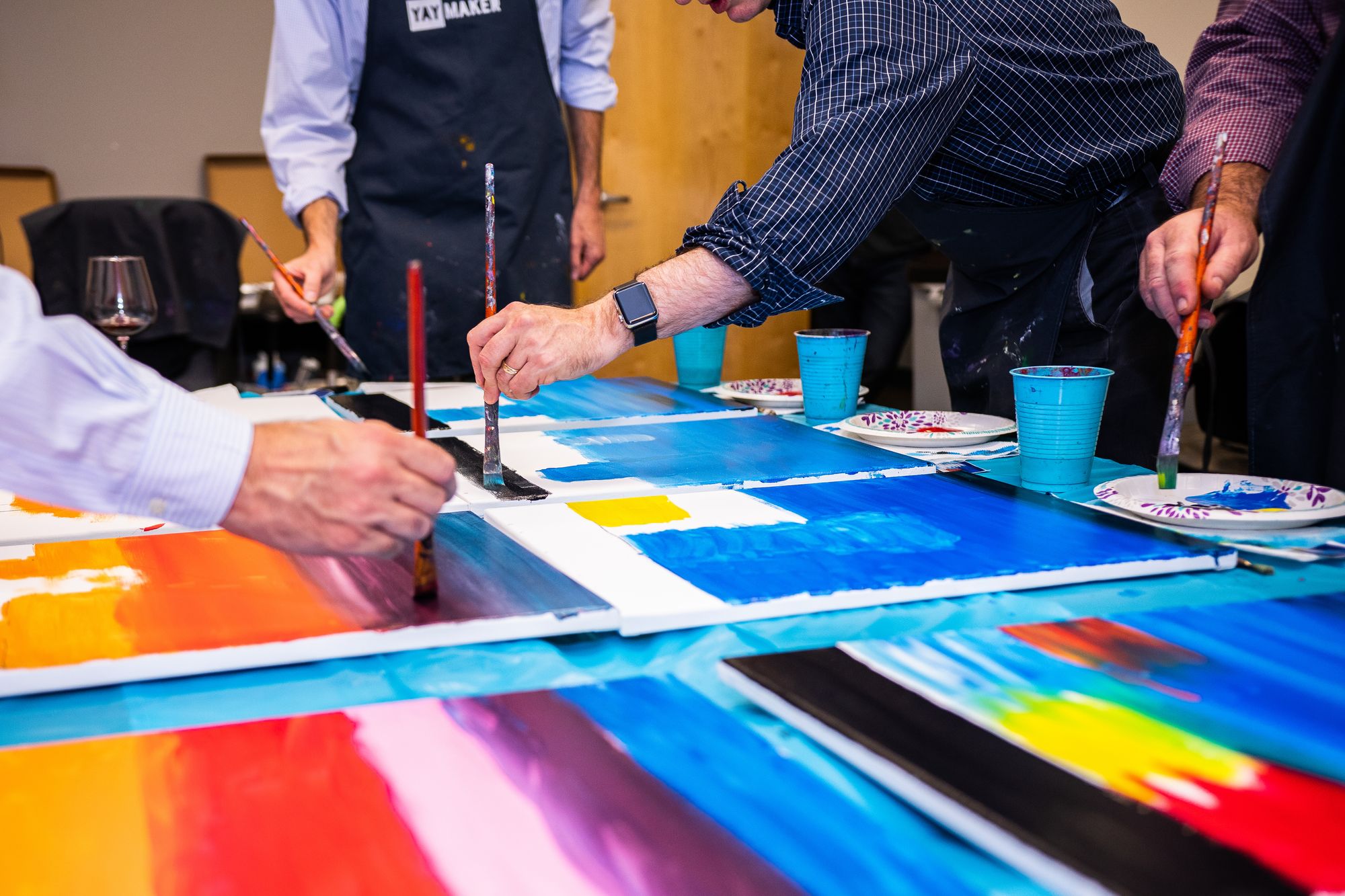 Men at a paint party team building event