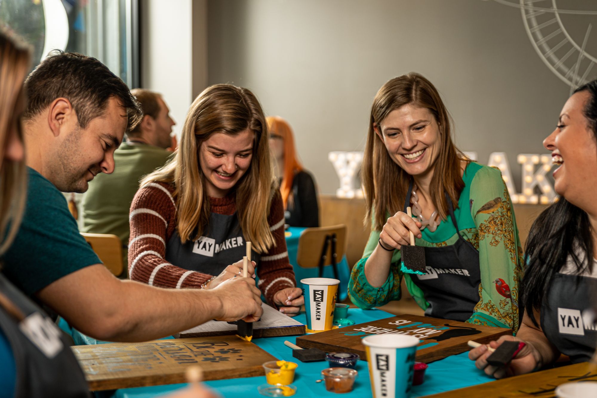 Team building event with Yaymaker painting wooden signs