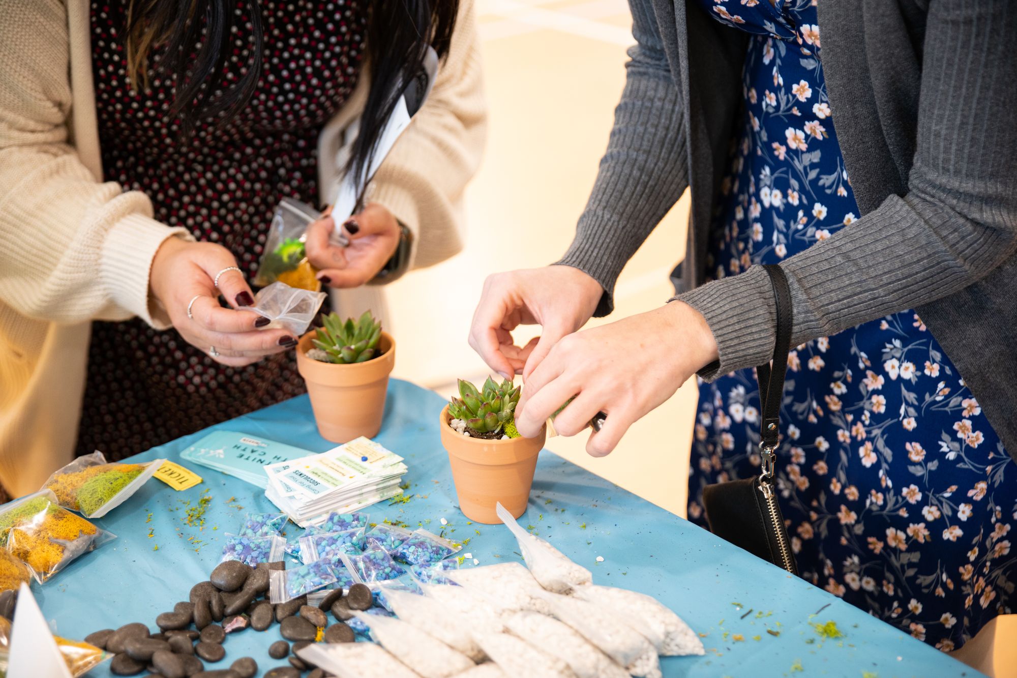 Women decorating planters at a Yaymaker private party