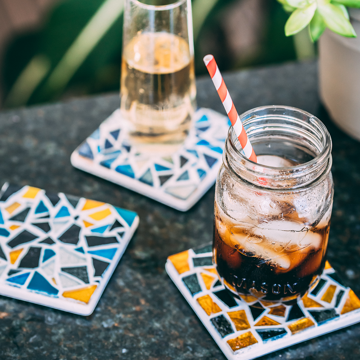 Three handmade mosaic coasters with drinks