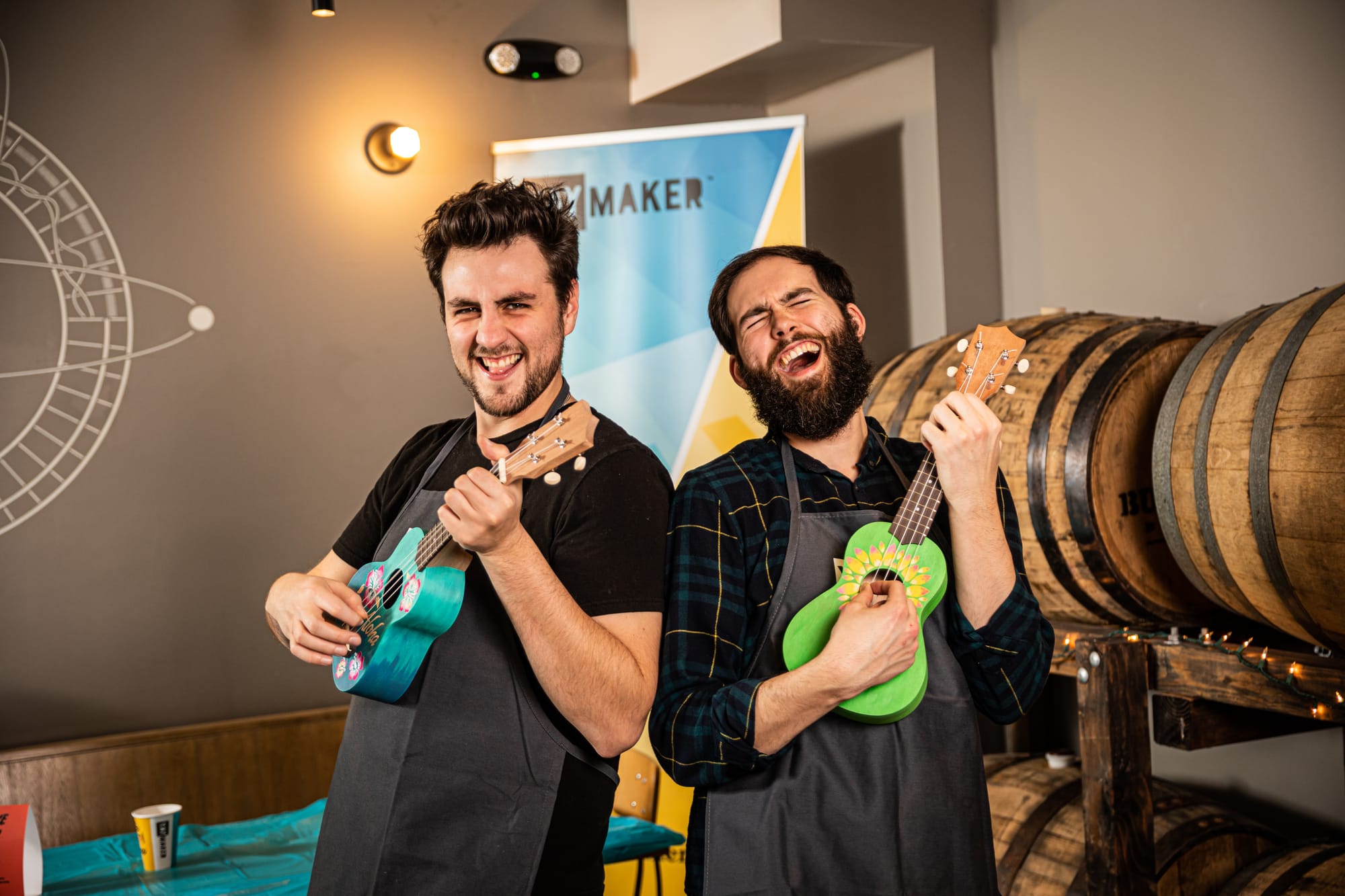 Two male friends playing with hand painted ukuleles from Yaymaker