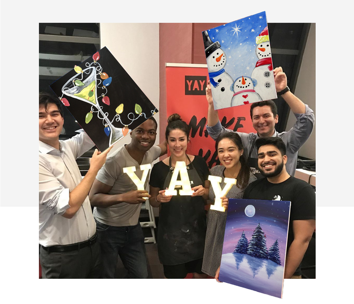 Inclusive work holiday party with Yaymaker | Guests showing finished paintings